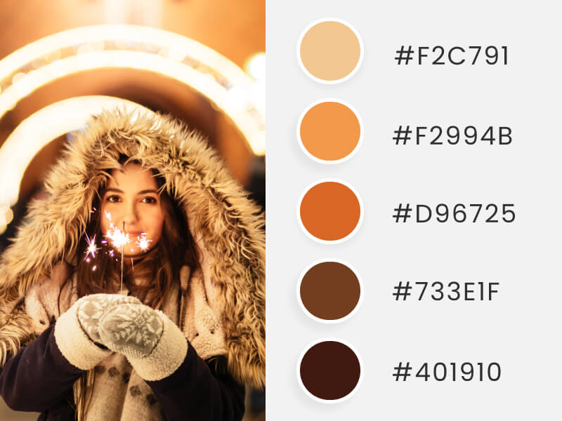 Palettes de couleurs d'hiver - une jeune fille portant des vêtements d'hiver tout en tenant une fusée éclairante